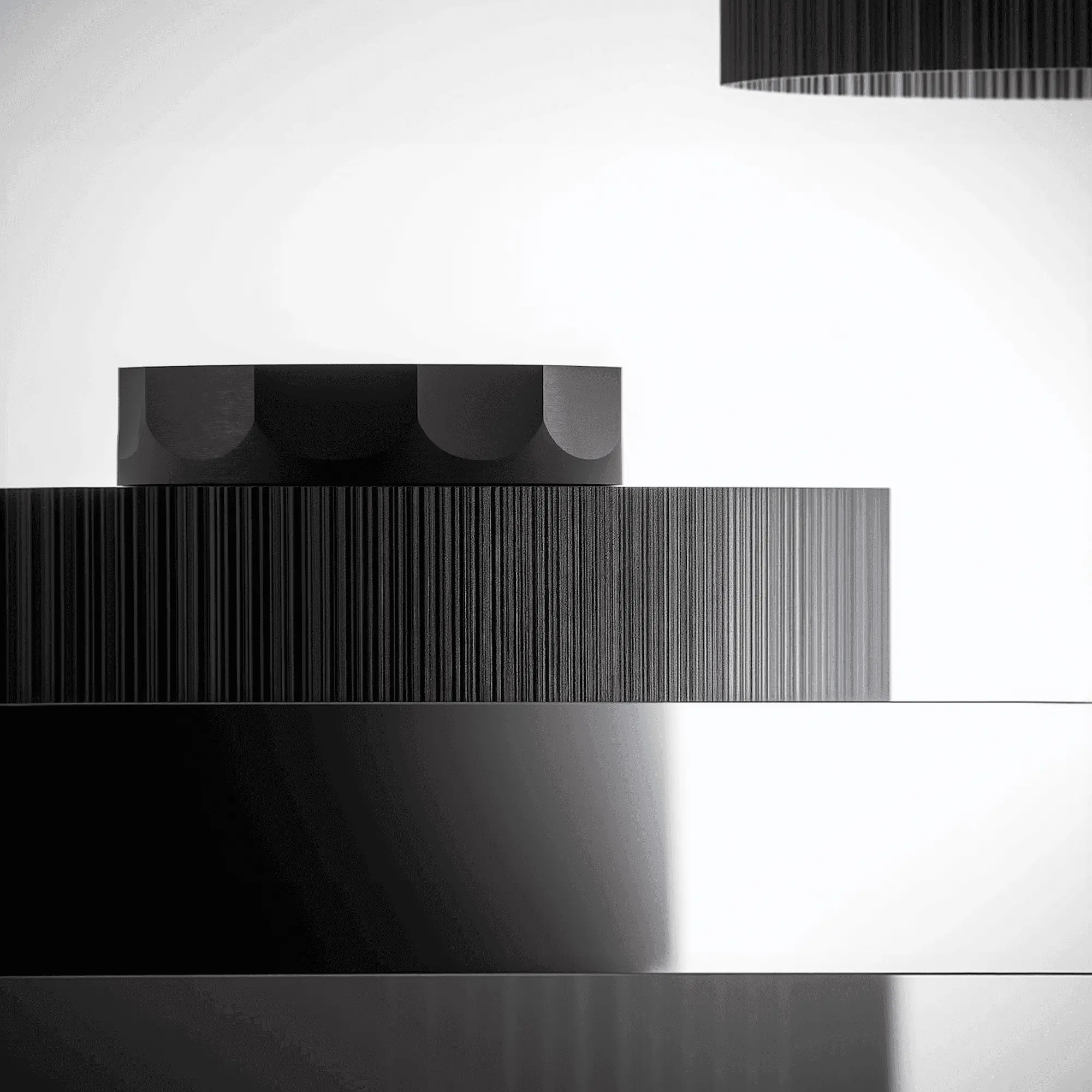Stacked black discs in soft monochrome light