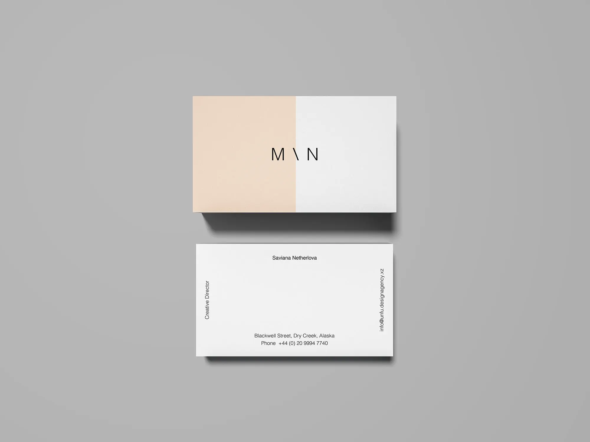 The front and back of a business card mockup on grey