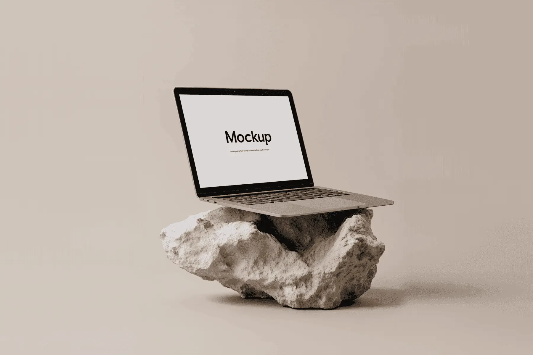 A laptop mockup balanced on a white rock