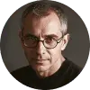 Portrait of Michael Rosenberg, a grey-haired man in round glasses